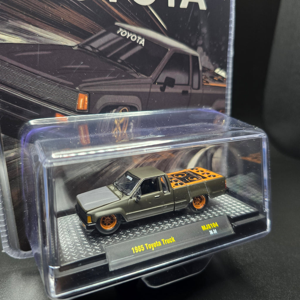 M2 Machines 1:64 1985 Toyota Pickup Truck Slammed Custom – Matte Grey w/ Carbon Hood
