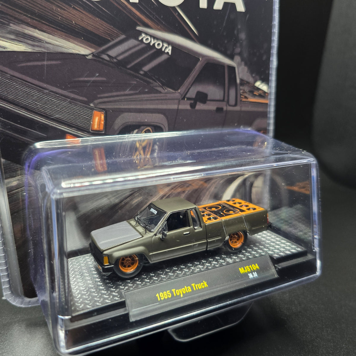M2 Machines 1:64 1985 Toyota Pickup Truck Slammed Custom – Matte Grey w/ Carbon Hood